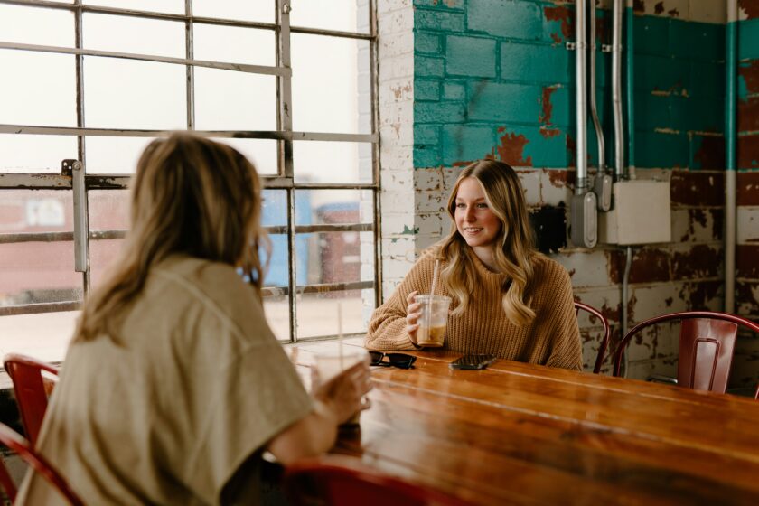 women talking at a cafe